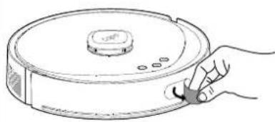 Line drawing of a hand holding a cleaning brush next to a circular device with a lid (no text or symbols)