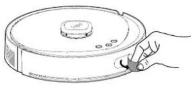 Line drawing of a hand holding a robotic vacuum cleaner (no text or symbols)