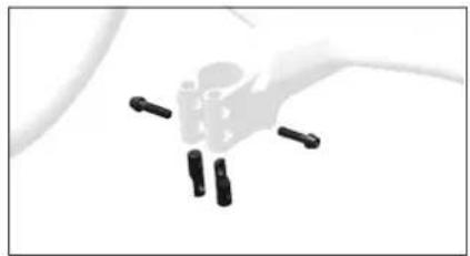 Close-up of a hand holding four black cylindrical objects (no text or symbols visible)
