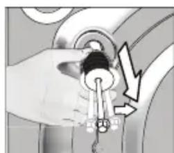Hand holding a key inserted into a circular component, with a lightning bolt symbol indicating compression (no text or labels)