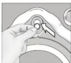 Close-up of a hand pressing a button on a mechanical component (no text or symbols visible)