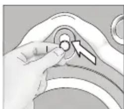 Close-up of a hand pressing a button on a mechanical component (no visible text or symbols)