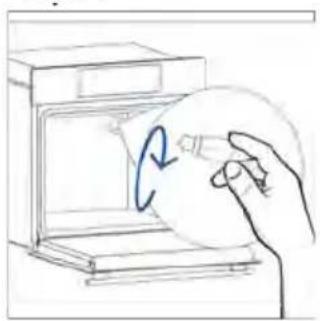 Hand holding a circular object inside a kitchen appliance (no text or symbols visible)
