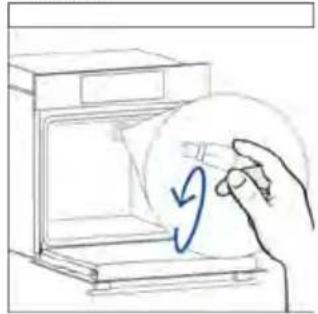 Hand placing a circular diagram with arrows inside an open appliance (no text or symbols)