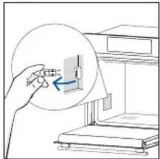 Illustration of a hand inserting a small component into a device, with no visible text or symbols.