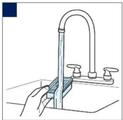 Illustration of a hand using a tool to clean or install a stainless steel sink with multiple washers (no text or symbols visible)