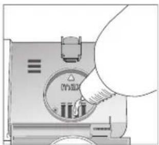 Diagram showing a hand inserting a component into a device with labeled parts and a warning symbol.