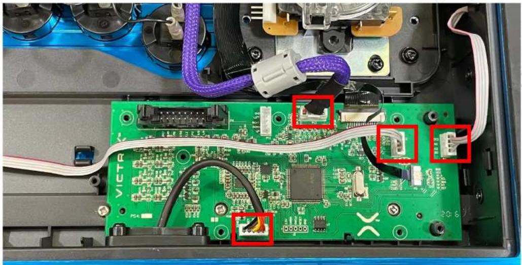 Interior view of an electronic device showing a green circuit board with connectors and wiring, no visible text or symbols.
