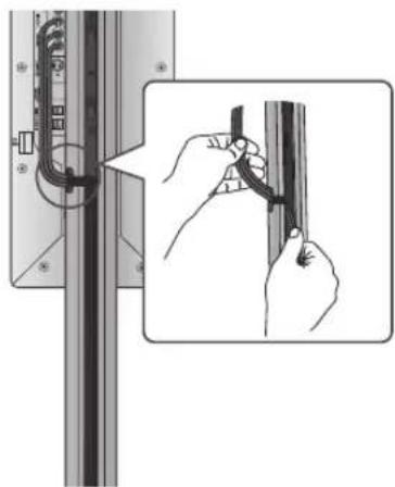 Illustration of hands installing or adjusting a cable or wire component on a vertical panel (no text or symbols visible)