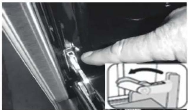 Close-up of a finger pressing a small mechanical component, with an inset showing a hand operating a workbench (no text or symbols visible).