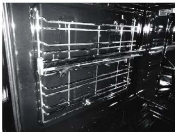 Interior view of a large industrial or laboratory chamber with metal grating and transparent panels, no visible text or symbols.