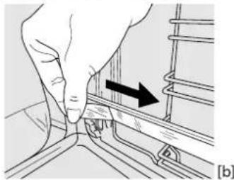 Hand pressing a component on a rail track, showing a black arrow indicating direction (no text or symbols present)