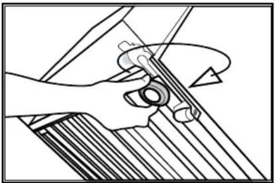Mechanical diagram showing hands operating a tool with a circular component, no text or symbols present.