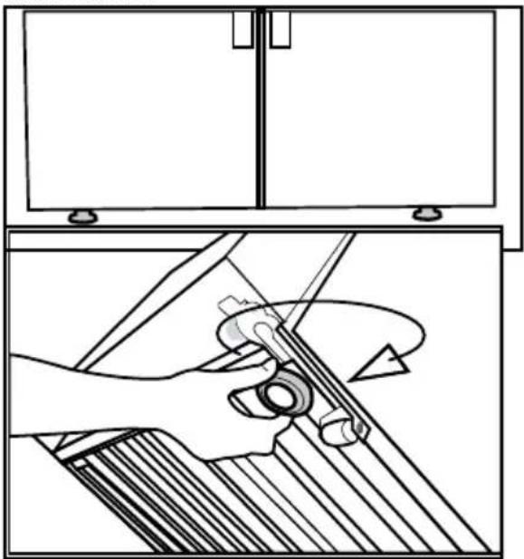 Technical line drawing showing a hand operating a tool with an arrow indicating rotation (no text or symbols present)
