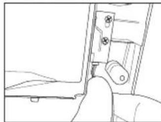 Line drawing of a hand inserting a component into a device (no text or symbols)