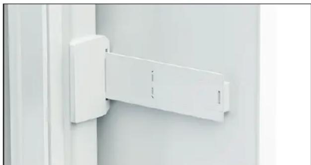 Close-up of a white wall-mounted bracket or bracket mounted on a vertical panel, no visible text or symbols.