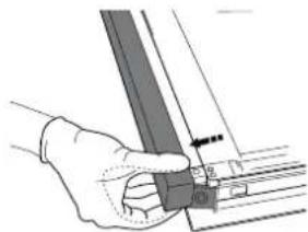 Hand holding a metal bracket with a pointer and measurement markings (no text or symbols visible).