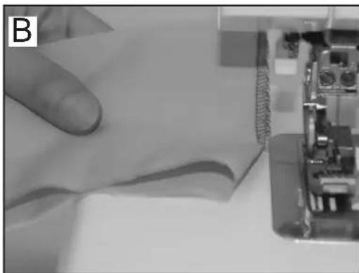 Close-up of a sewing machine stitching fabric, with no visible text or symbols