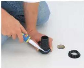 Child's hands assembling a plastic tire and ring on a white surface (no text or symbols visible).