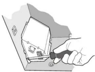Illustration of a hand using a screwdriver to adjust or install electronic components on a device (no text or symbols visible)