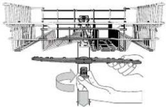 Technical diagram showing a mechanical assembly with labeled components and a hand holding a tool, likely illustrating a process or assembly procedure.
