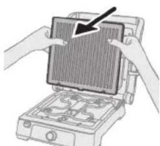 Illustration of hands installing a grid on an electronic device (no text or symbols visible).