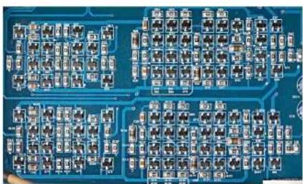 Close-up of a blue printed circuit board with integrated circuits and traces (no visible text or symbols)