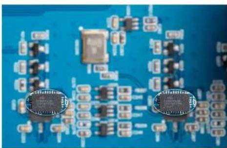 Close-up of a blue printed circuit board with integrated circuits and traces (no visible text or symbols)