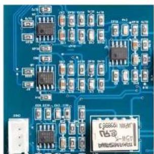 Close-up of a blue printed circuit board with integrated circuits and connectors (no readable text or symbols)