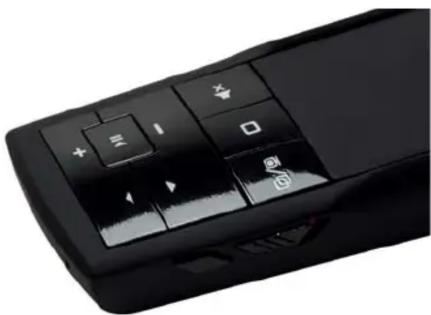 Close-up of a black remote control with function keys and navigation buttons (no readable text or symbols)