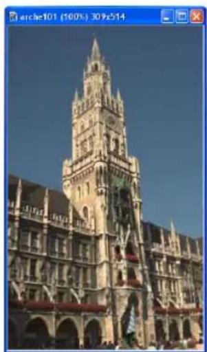Exterior view of a Gothic-style building with a tall spire under a clear blue sky (no signage or text visible)