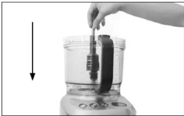 Person using a kitchen blender with a hand adjusting the lid (no text or symbols visible)
