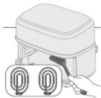 Illustration of a hand holding a brush applying material to a device with two circular components below (no text or symbols)