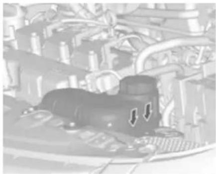 Close-up of a car engine bay with visible pipes and structural components (no text or symbols)