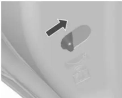 Close-up of a capsule-shaped object with an arrow pointing upward, placed on a textured surface (no text or symbols visible)
