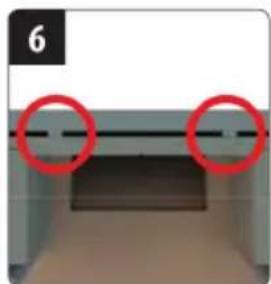 Close-up of a mechanical component with two red circles highlighting features (no text or symbols visible)