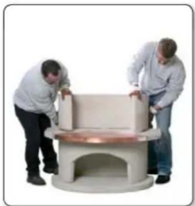 Two people examining a large cylindrical object with copper base, possibly a table or bench (no visible text or symbols)