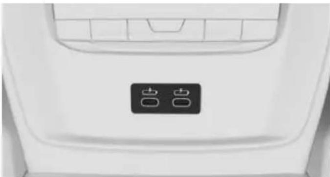 Close-up of a white car backrest with two black buttons on the front panel (no text or symbols visible)
