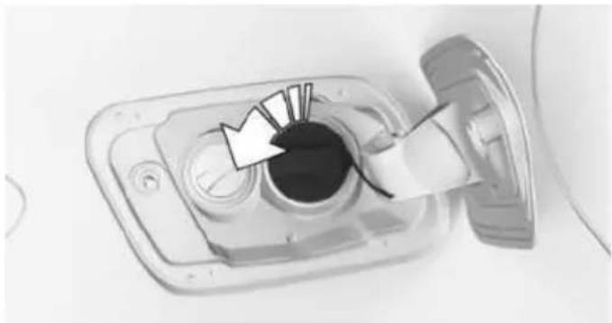 Close-up of a mechanical component with a circular opening and a white arrow pointing to it, no visible text or symbols.