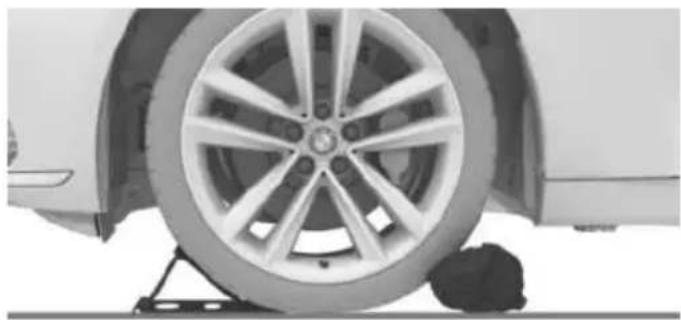 Close-up of a car wheel mounted on a platform, showing tire and wheel rim (no text or symbols visible)