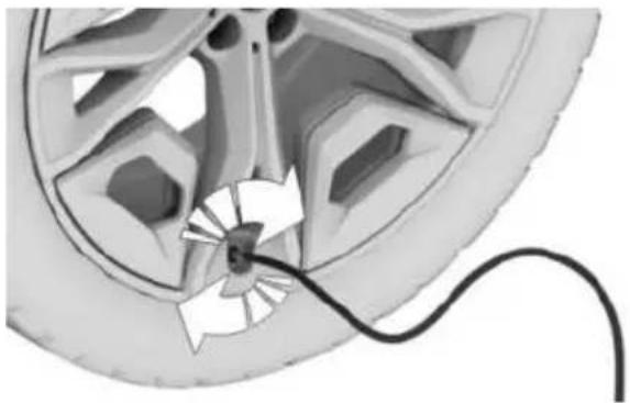Close-up of a car wheel with a cable inserted, showing internal components and a cable (no text or symbols visible)