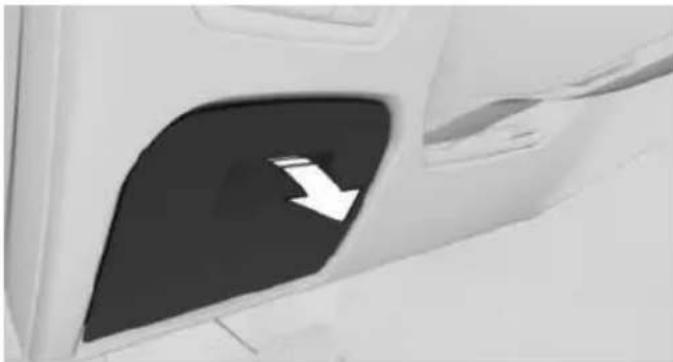 Close-up of a car door with a white arrow pointing to the side panel (no text or symbols visible)