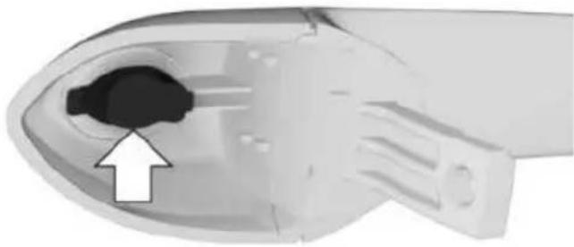 Close-up of a medical device component with an arrow pointing to a black hole (no text or symbols visible)