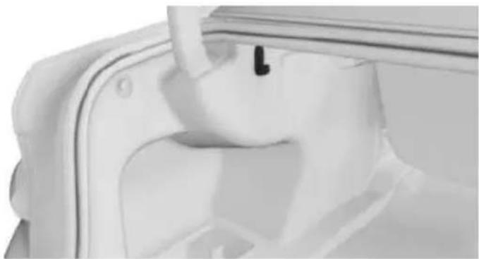 Close-up of a white plastic container with a handle and a small black mark on the side (no text or symbols visible)