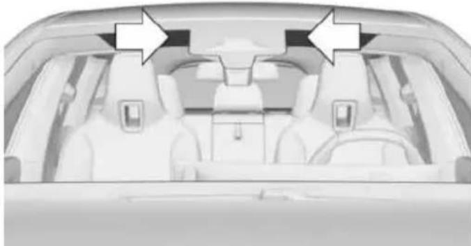 Interior view of a car showing three seats and two rear seats, with two white arrows pointing to the front seat (no text or symbols present)