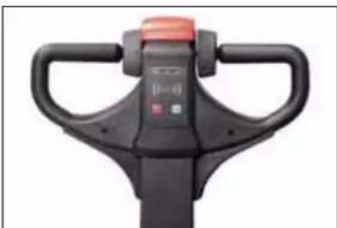 Close-up of a black manual pallet jack with handle and control knob (no visible text or symbols)