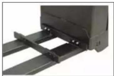 Close-up of a black mechanical component with metal brackets and mounting holes (no visible text or symbols)