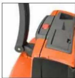 Close-up of an orange industrial machine component with black handle and control panel (no visible text or symbols)