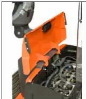 Close-up of an orange industrial machine component with visible internal wiring and mounting bracket (no text or symbols)