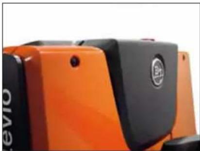 Close-up of an orange and black electronic device with a circular logo (no readable text or symbols)